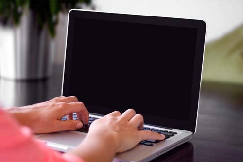 view of hands using laptop