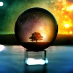 A mesmerizing scene of a tree and stars in a crystal ball with vibrant bokeh lights.